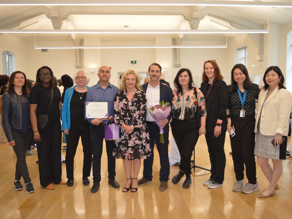 Members from the Department of Languages, Literatures, and Cultures dressed in semi-formal attire posing alongside Provost Roberta Iannacito-Provenzano and Interim Dean of Arts Amy Peng. 